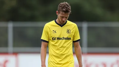 A 30-year-old KV Mechelen player, wearing a yellow jersey, looks dejected after missing a chance, photographed with a...