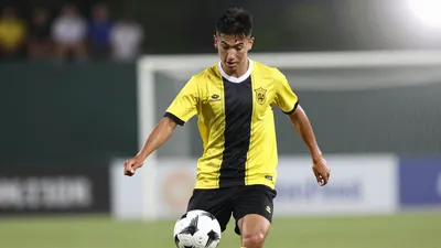 A photorealistic image of an anonymous 24-year-old central defender, wearing a yellow and black jersey with a white...